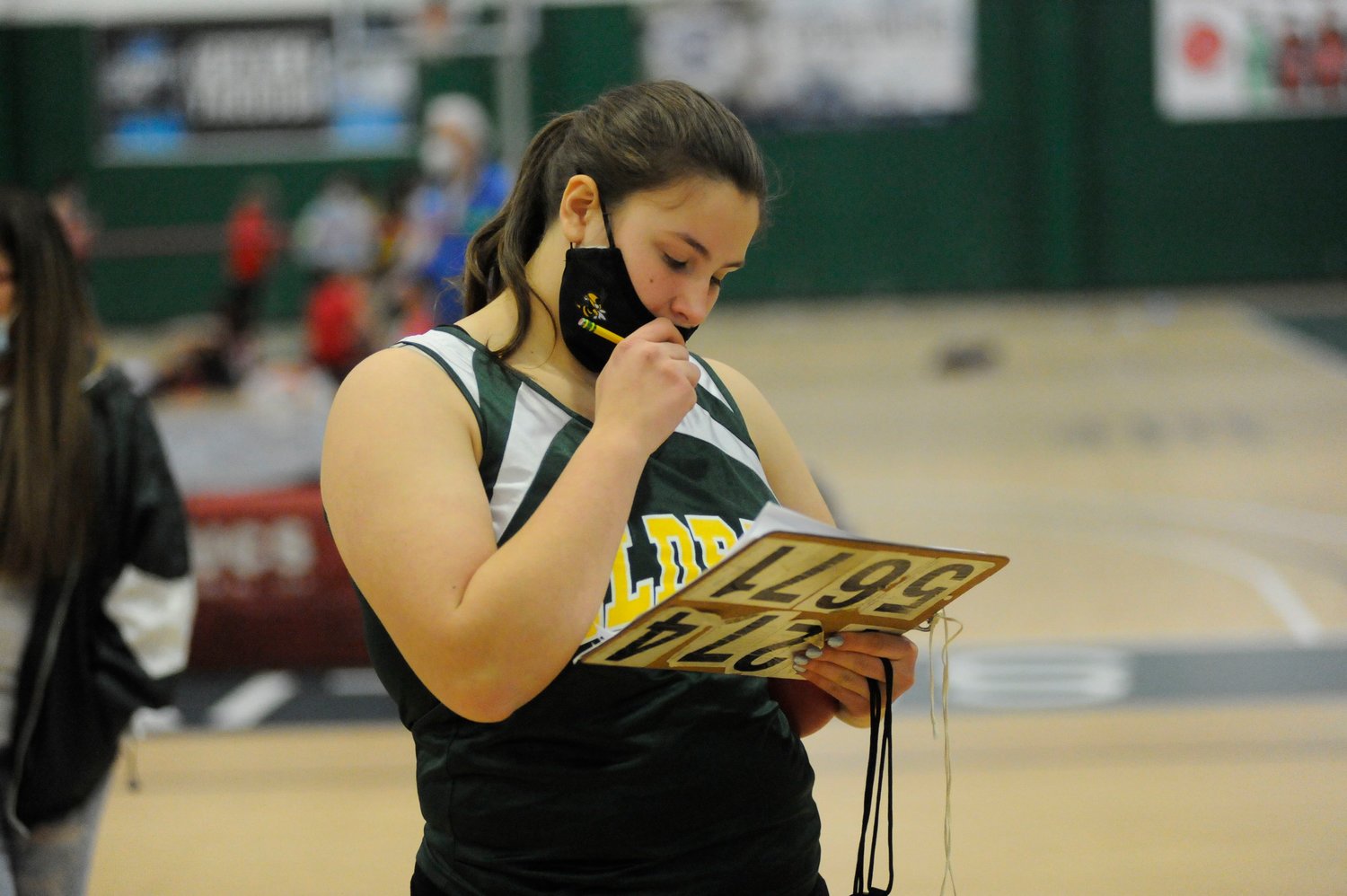 Eldred’s Ksenia Sosnowski keeps tabs on the Yellowjackets' shot-putters. She placed sixth in the girls’ varsity event.